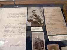Display of letters and photographs, one showing Tolstoy as a young man